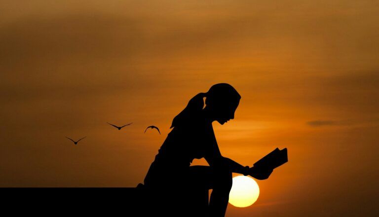 Una mujer leyendo mientras el sol del verano se encamina al ocaso.